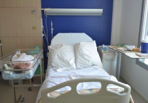 newborn in incubator inside a hospital room